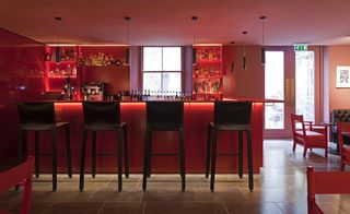 The architect outfitted the Shenkman Bar in phone-box red and added atmospheric lighting.