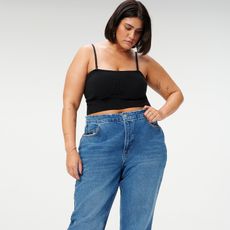 Model wears black tank and good american 90s relaxed jeans 