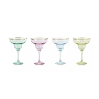 Four glass margarita glasses - one green, one dusky pink, one light blue, and one yellow - all with gilded gold rims