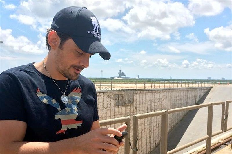 Country music star Brad Paisley uses his phone to &#039;leak&#039; his new song, &quot;American Flag on the Moon&quot; from NASA&#039;s historic Launch Pad 39B at the Kennedy Space Center in Florida.