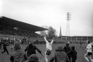 Fans run onto the pitch as Ronnie Radford celebrates after scoring Hereford United's equalising goal against Newcastle United in the FA Cup, 1972