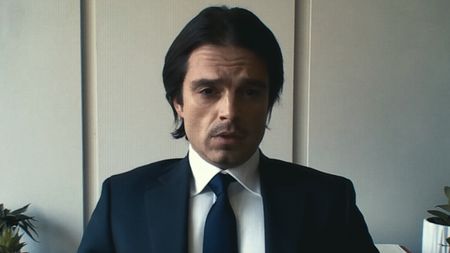 Vlad sitting in office during video meeting with Alexandria Ocasio-Cortez in Dumb Money