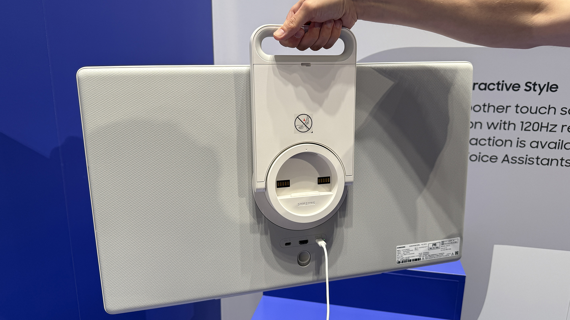 Samsung&#039;s The Movingstyle TV shown from the rear, being held up my a man&#039;s arm