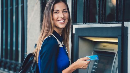 Student in front of ATM machine.