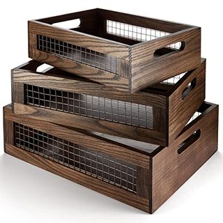 Wooden storage crates with mesh sides. Three sizes stacked on top of one another