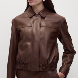 Image of a woman wearing a brown leather jacket