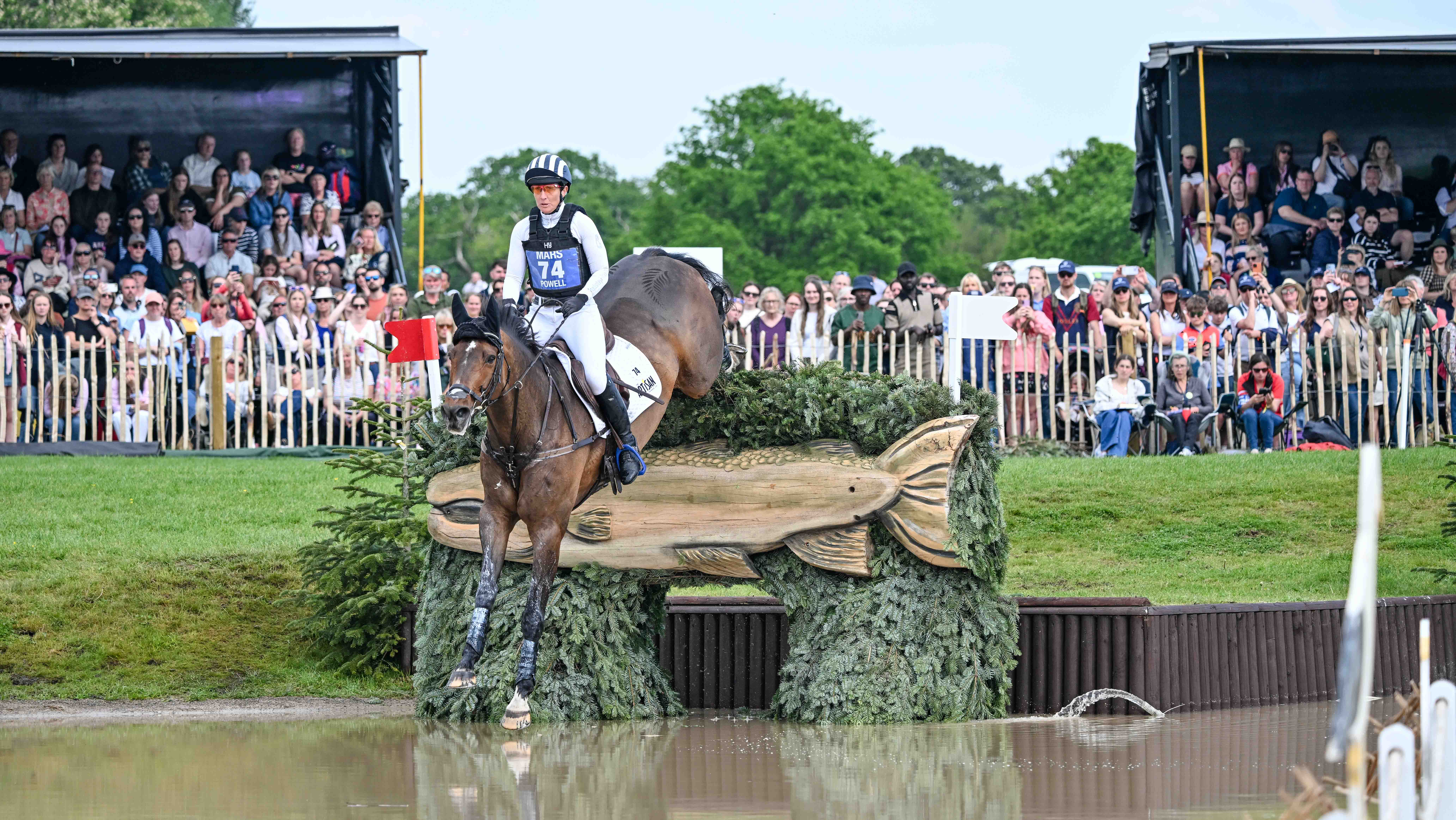 Caroline Powell and Greenacres Special Cavalier jump a cross-country fence into The Lake at Badminton 2026.