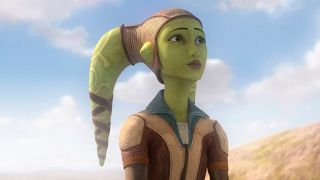 Hera Syndulla is a green-skinned Twi'lek with two head tails (known as lekku) protruding from the top left and right of her head. She is wearing a brown leather cap and a brown and cream leather jacket. She is looking off into the distance. Behind here is a light blue cloudy sky.