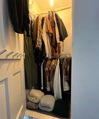 A small awkward closet with an orange light at the top