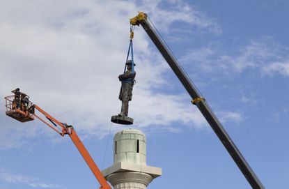 A statue of Confederate General Robert E. Lee is removed in New Orleans.