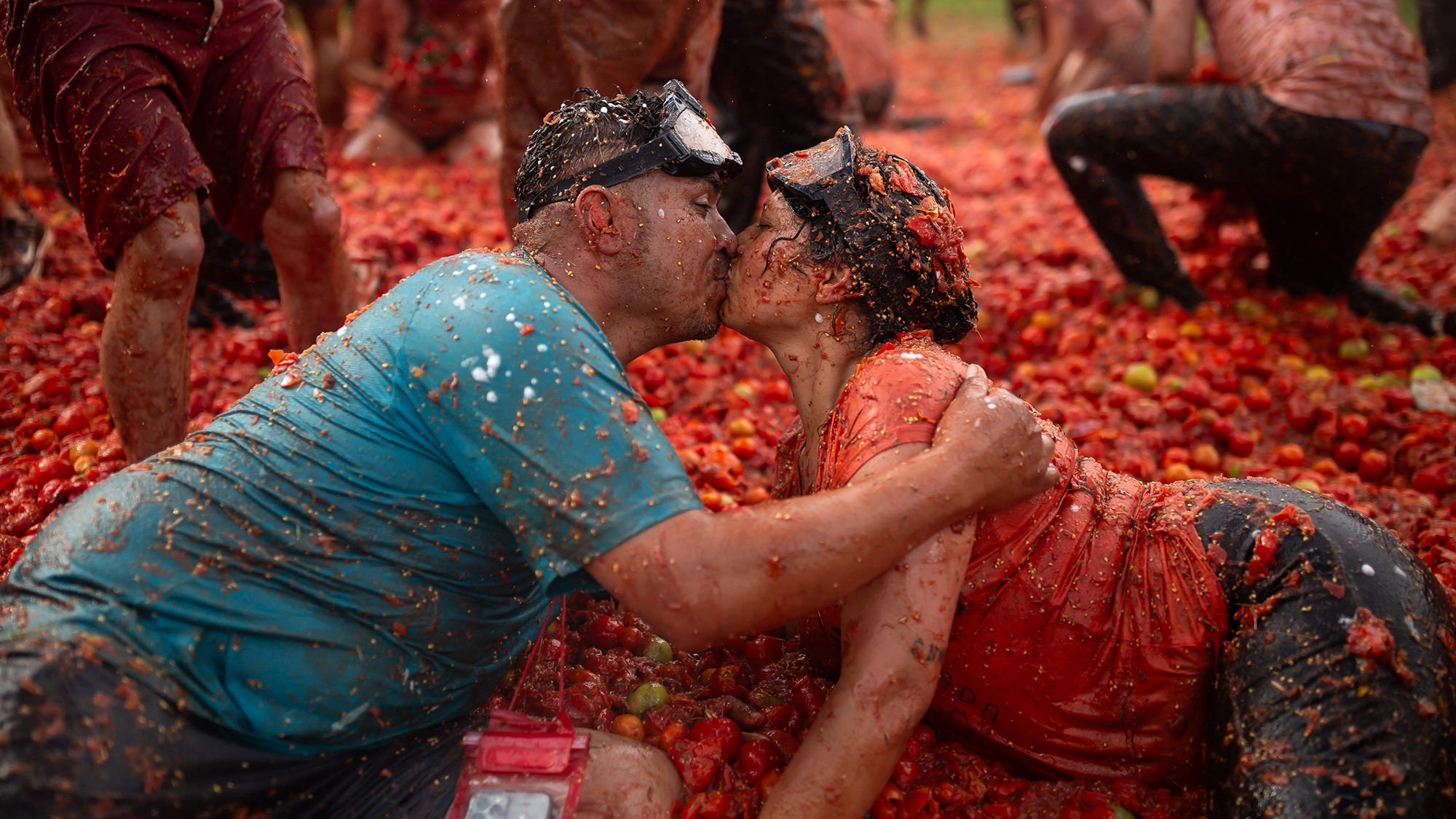 A couple kisses during the Great Colombian Tomatina, an annual food fight involving 40 tons of tomatoes, in Sutamarchan, Colombia