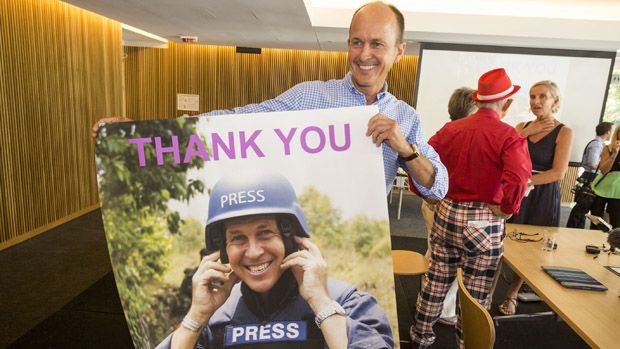 Peter Greste&amp;#039;s brother, Andrew, holding a picture of Peter