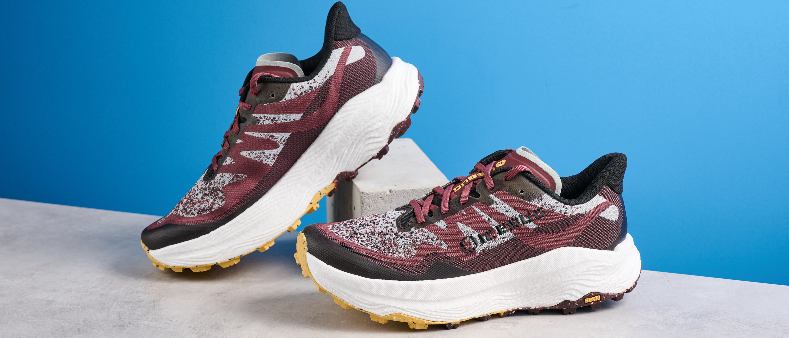 the icebug j&auml;rv rb9x trail running shoes in cherry and banana photographed against the tom's guide blue background