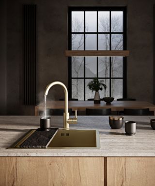 A gold hot water tap in a kitchen island