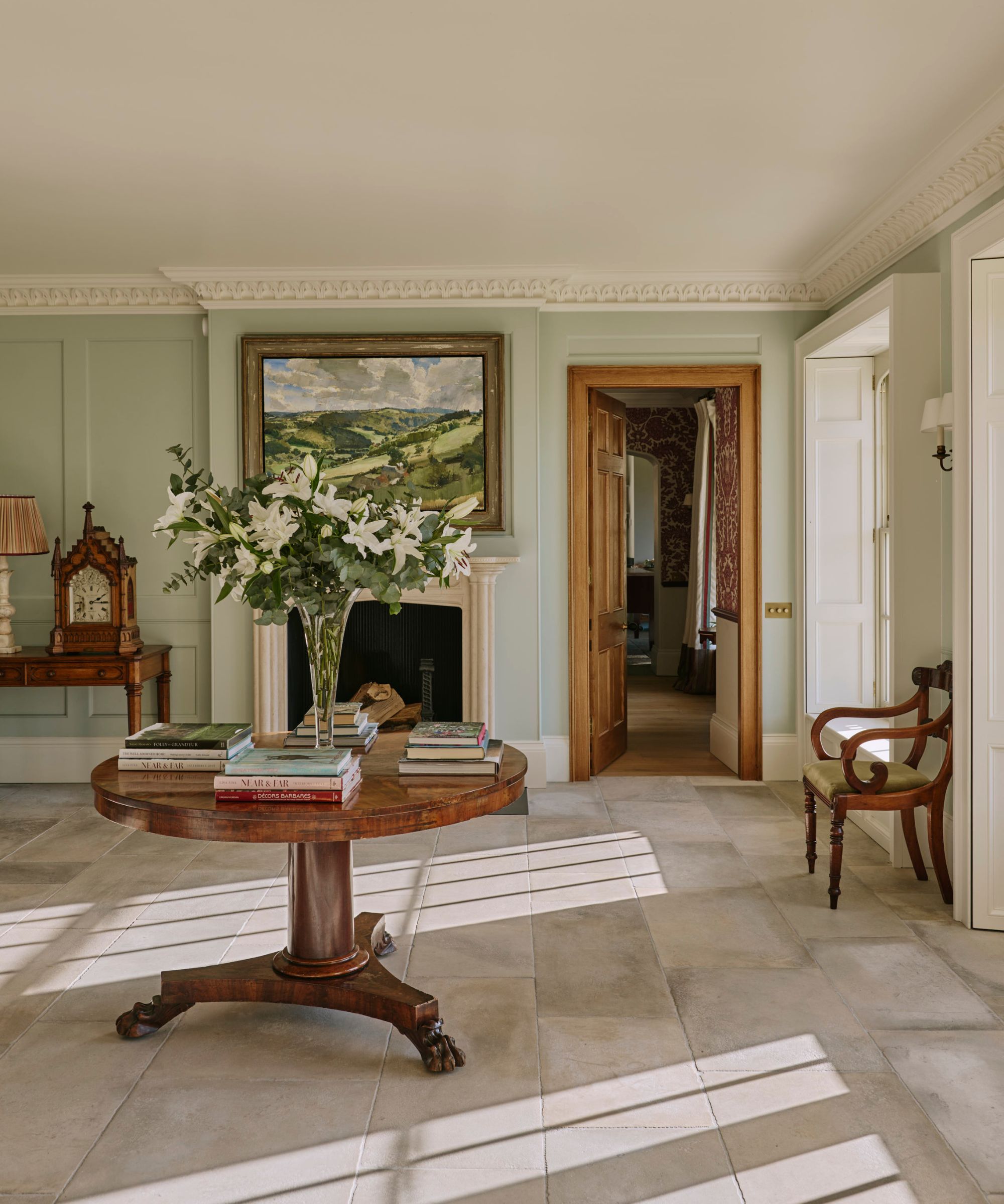 A large hallway with a dining table at the center to be used as a multi functional room