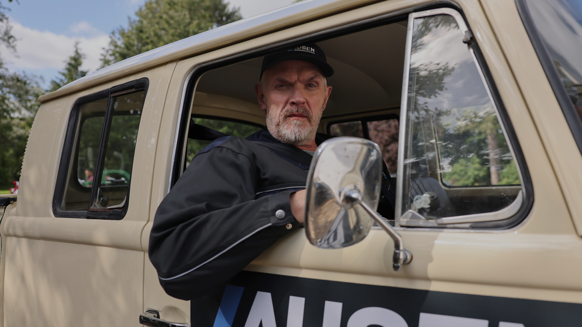 Bearded comedian Greg Davies looks grumpily out of the window of a vintage beige work truck as Paul &#039;Wicky&#039; Wickstead in season 3 of &quot;The Cleaner&quot;