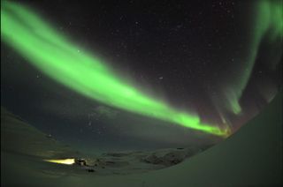 Intense Auroras Glow Over Hotel in Swedish Mountains by Chad Blakley