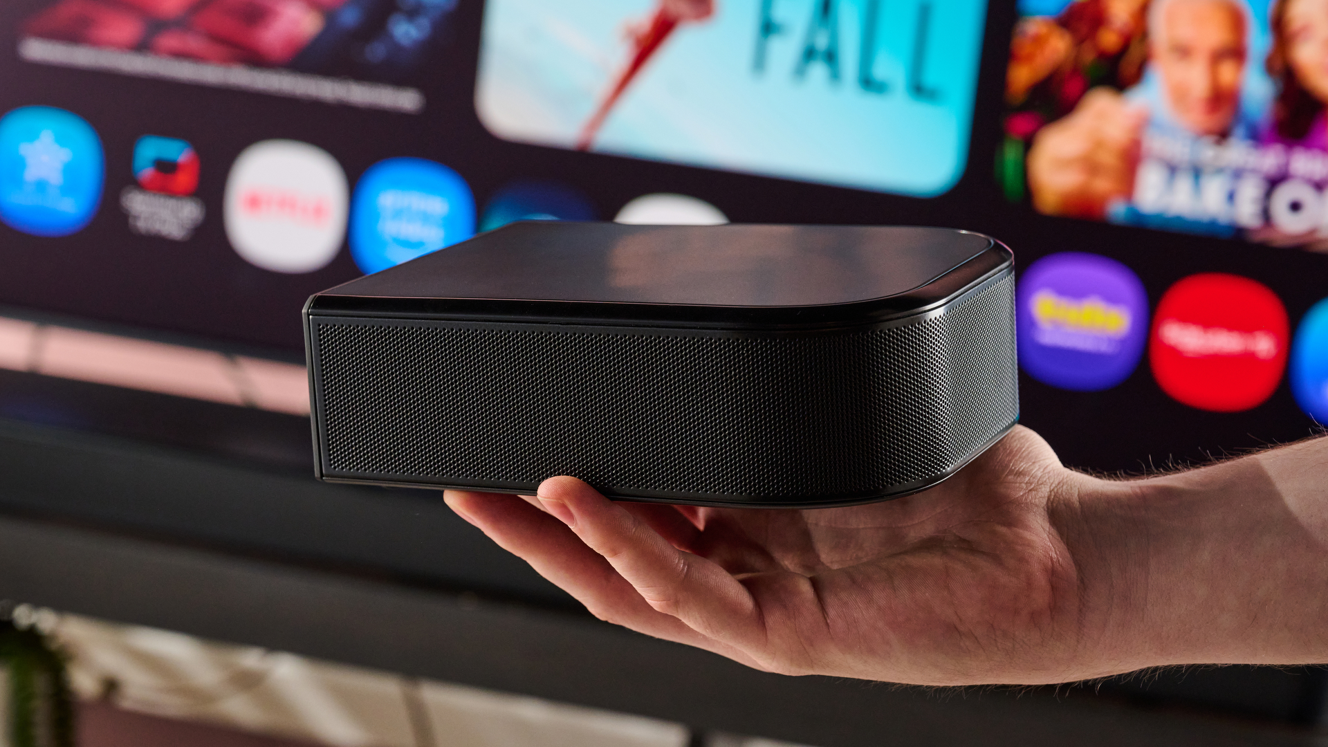 Man holding JBL Bar 800MK2 surround speaker