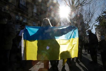 Woman holding Ukrainian flag. 