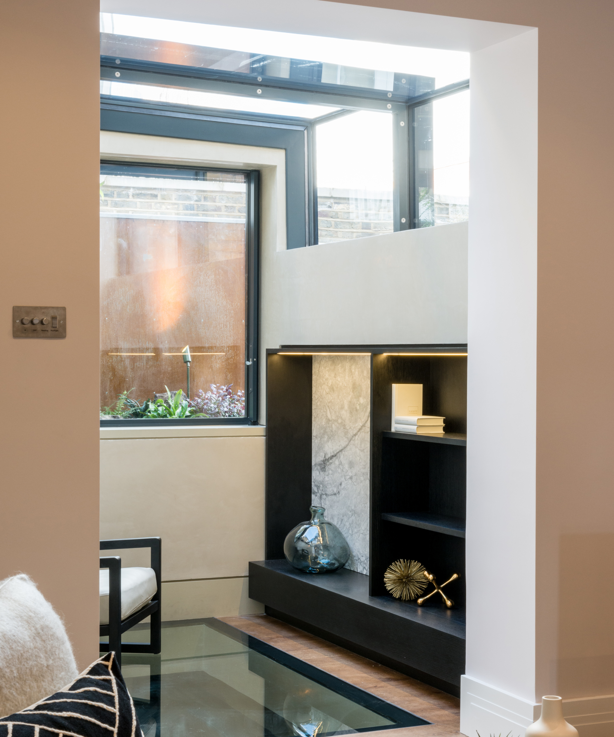 view of living space with glass roof extension, glass picture window and glass panel to floor