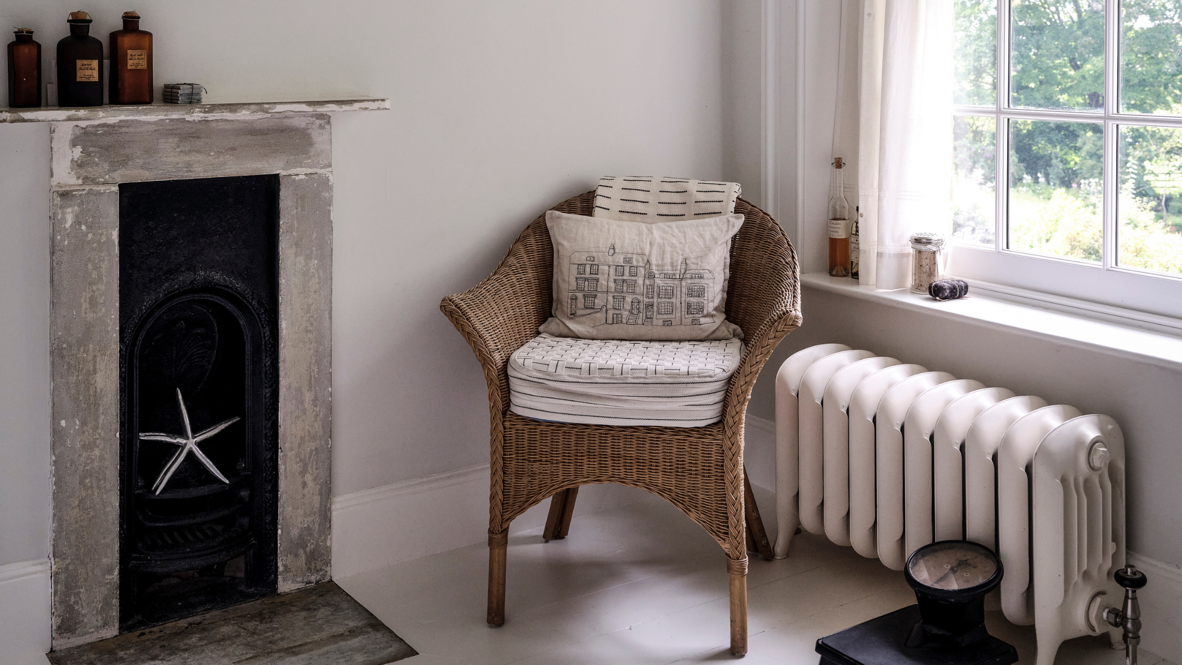 radiator, wicker chair and stone fireplace.
