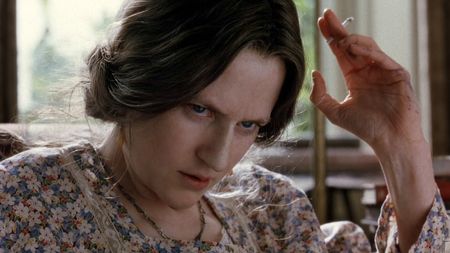 Nicole Kidman, in a prosthetic nose and smoking a cigarette as Virginia Woolf, in The Hours. 