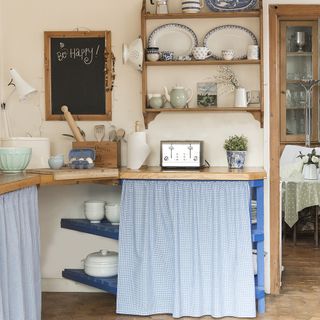 kitchen room with white wall and wooden kitchen counter with curtains