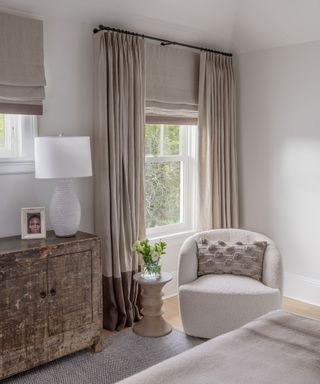 A seating area in the corner of a gray bedroom