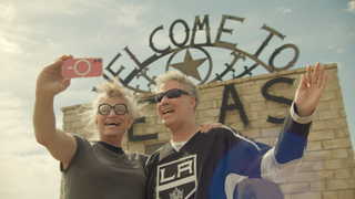 (From l to r) Harper Steele and Will Ferrell pose in front of a Welcome to Texas sign in Will & Harper on Netflix