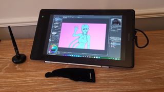 The Huion Kamvas Pro 16 on a wooden side table