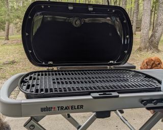 Close up shot of Weber Traveler gas grill being set up in writer's outdoor space