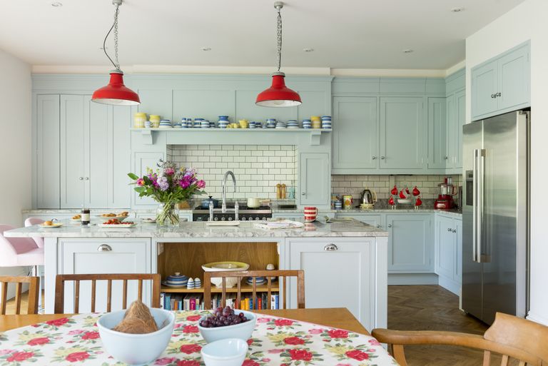 colourful family kitchen with kitchen island and table dressed in floral tablecloth