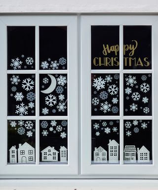 Snowy festive windowscape scene with snowflake flurry and village decals