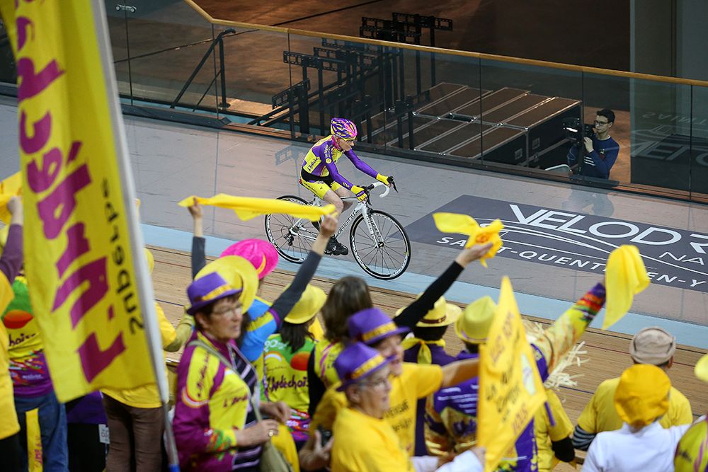 Fans cheer Robert Marchand during his attempt to break the 105+ world cycling hour record.
