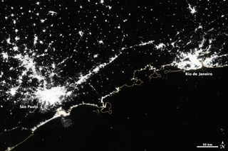 A satellite image shows Rio de Janeiro and Sao Paulo at night.