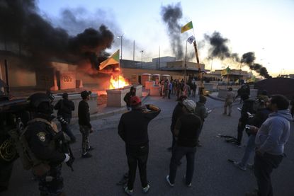 BAGHDAD, IRAQ - DECEMBER 31: Outraged Iraqi protesters storm the U.S. Embassy in Baghdad, protesting Washington's attacks on armed battalions belong to Iranian-backed Hashd al-Shaabi forces o