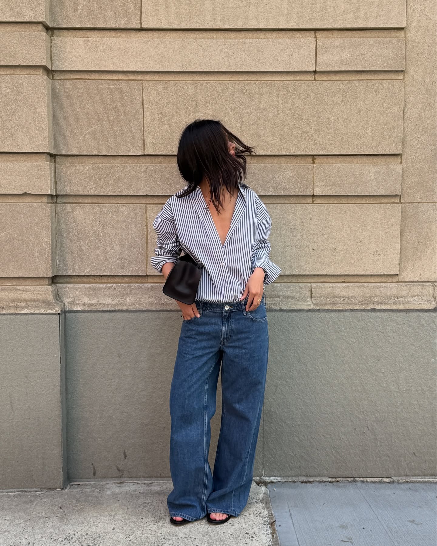 Woman in striped shirt and low-rise jeans.