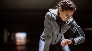 Woman checking sports watch during run