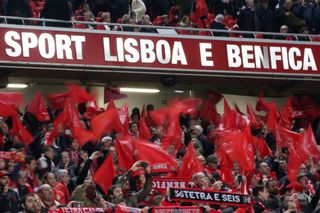 Benfica fans wave flags during a derby against Sporting CP in February 2019.