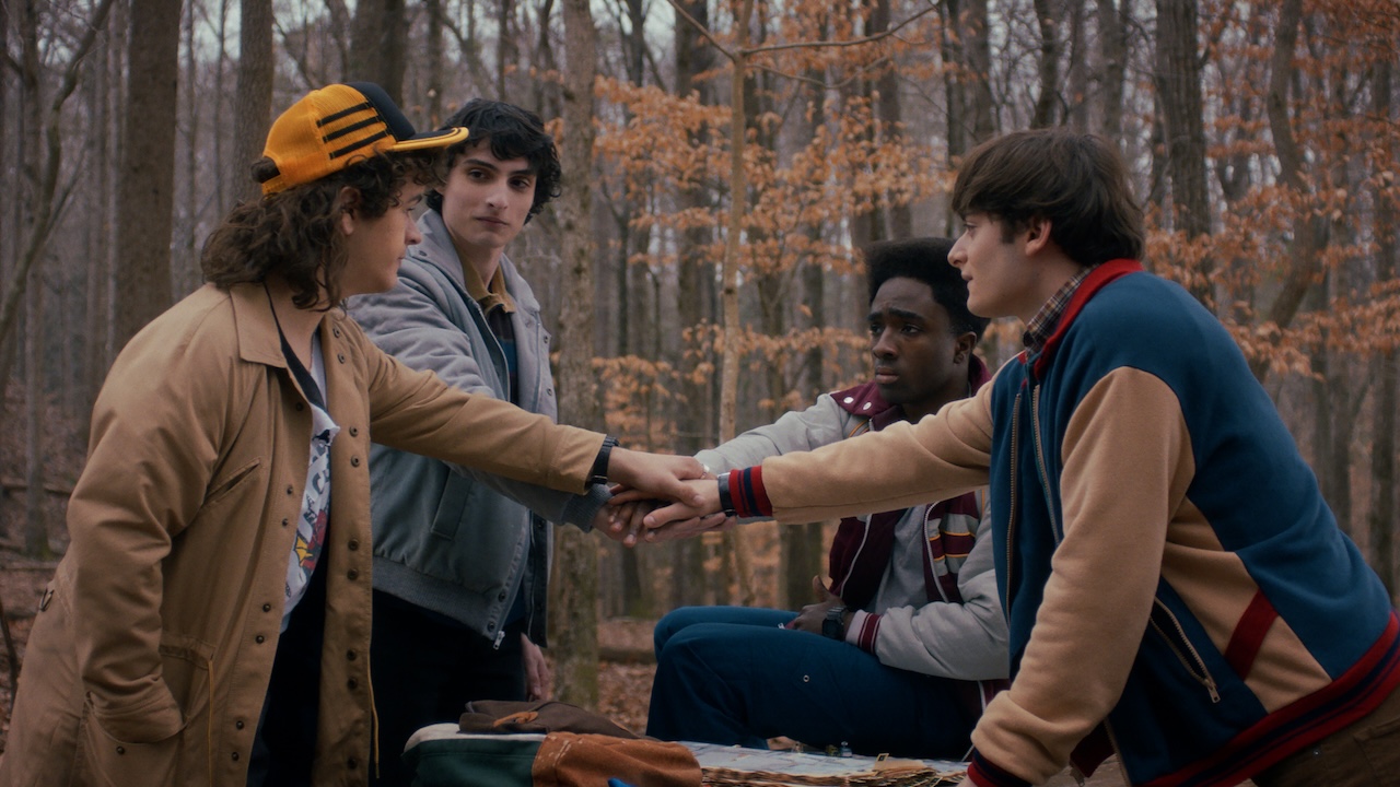Dustin, Mike, Lucas and Will hands in the middle in Stranger Things Season 5