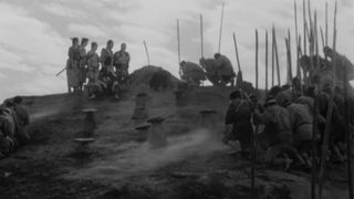 A group of samurai and a village bury one of their own in Seven Samurai