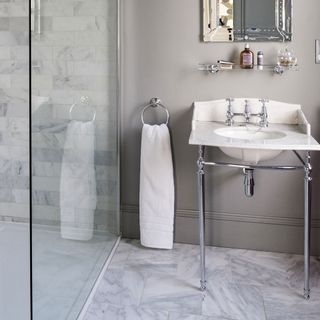bathroom with grey wall wash basin and shelf