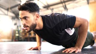 a photo of a man performing a push up