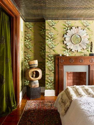 Bedroom with yellow floral wallpaper and copper ceiling tiles