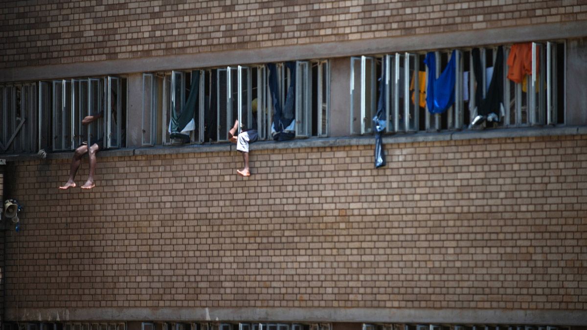 Inmates sit on the window of their cell in the Kgosi Mampuru II Prison where Oscar Pistorius spent part of his sentence, on December 1, 2015 in Pretoria.South Africa's Supreme Court of Appeal