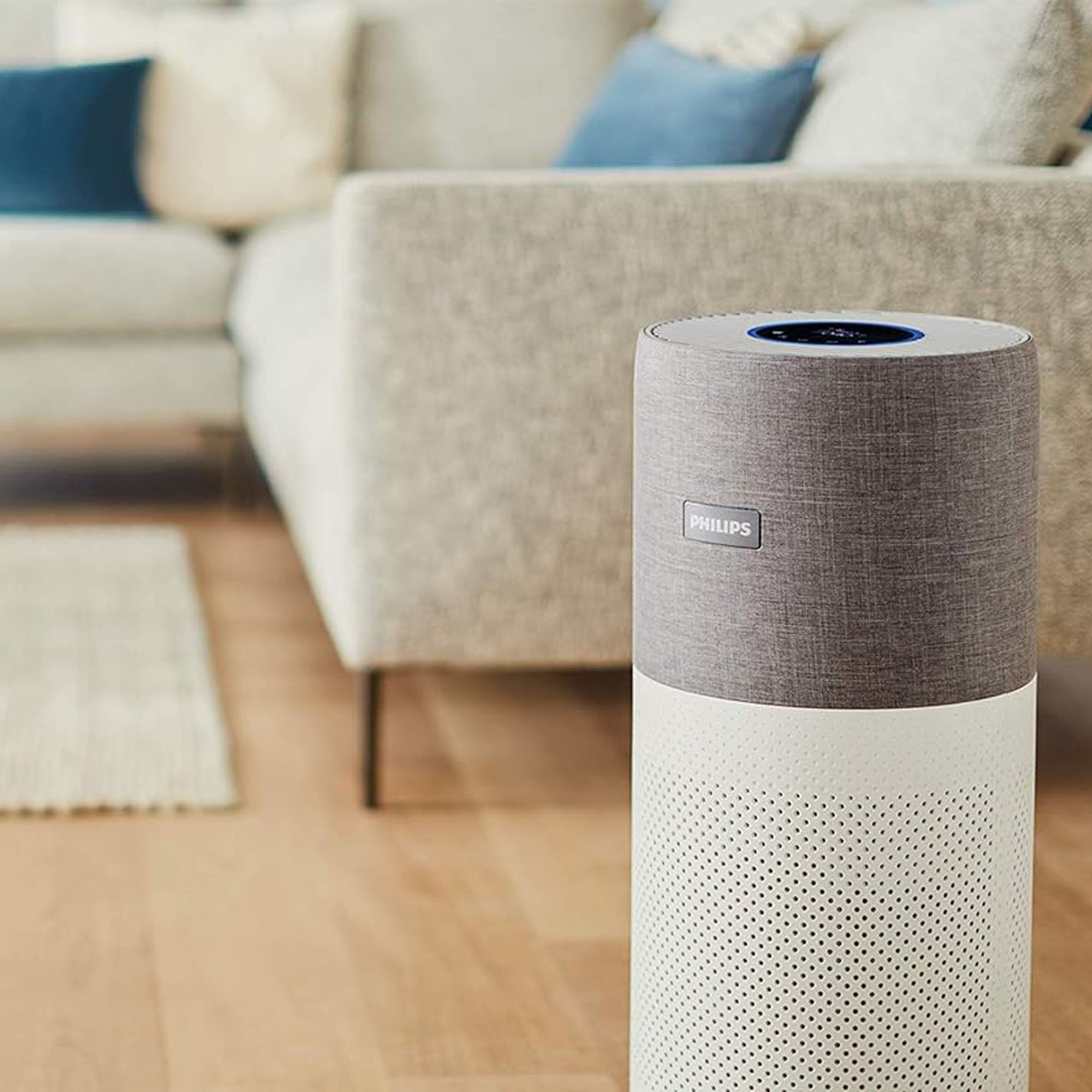 The Philips 3000i Series AC3033/30 Connected Air Purifier in a living room with a wooden floor