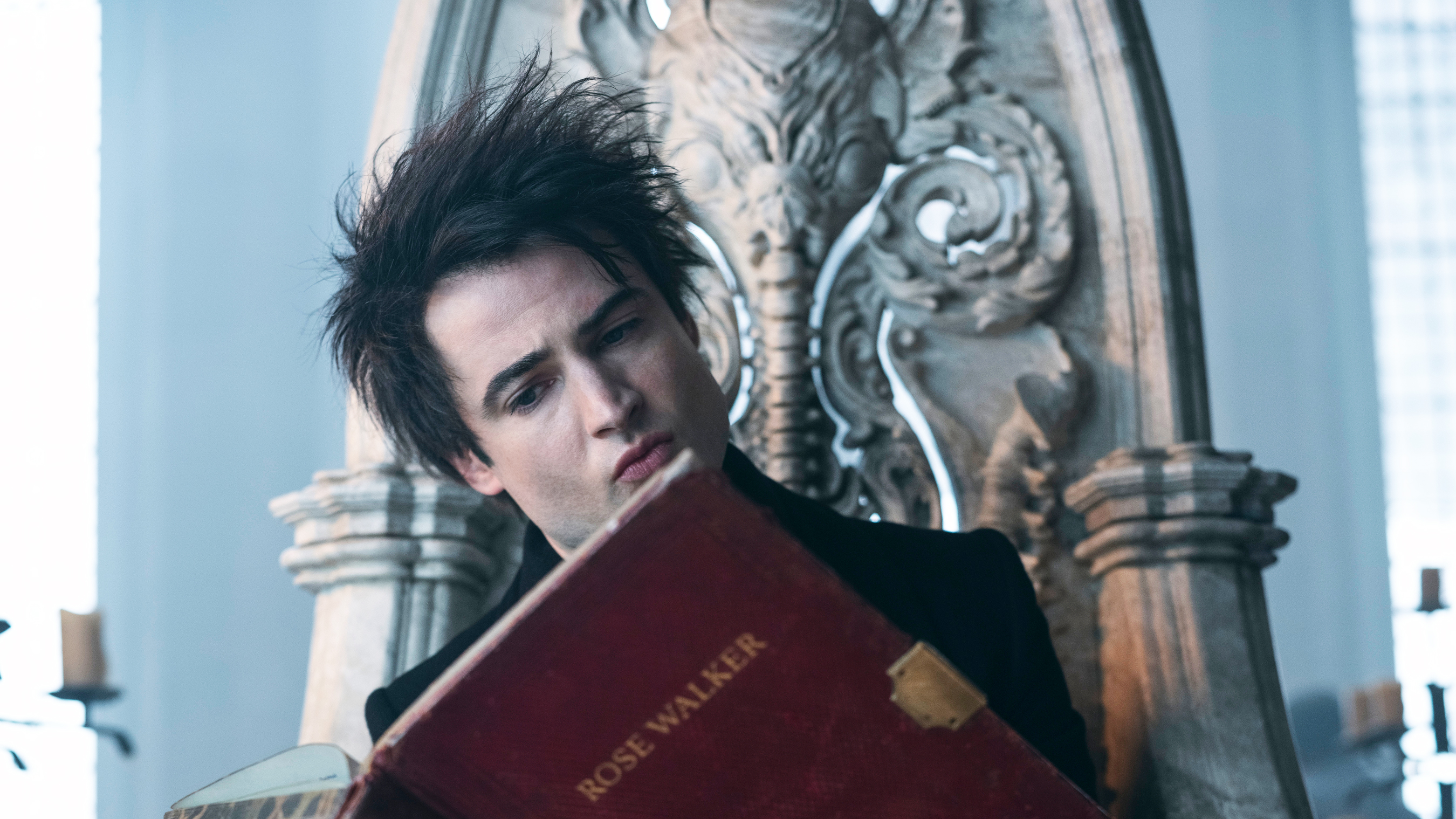 Tom Sturridge as Dream, reading Rose Walker's book in The Sandman