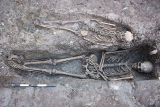 skeletons being unearthed at an excavation of a medieval knight's tomb