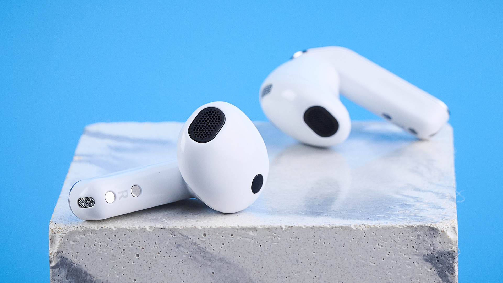 the samsung galaxy buds 4 photographed against the blue tom's guide background showing charging case and buds