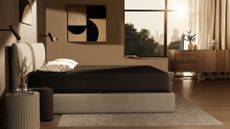The Eight Sleep Pod 4 on a mattress in a bedroom with the Pod 4 hub next to the bed